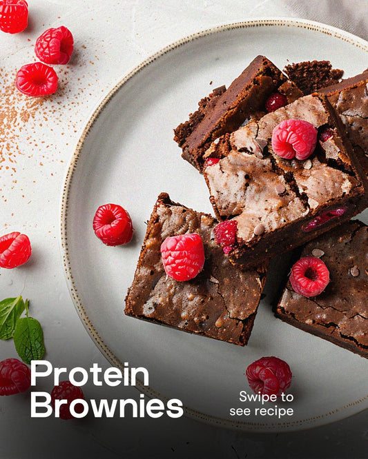 Protein brownies with raspberries on a white plate